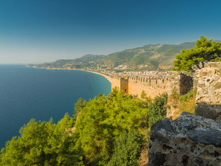Alanya, Turkey. Beautiful view from the fortress Alanya Castle of the Mediterranean Sea and Cleopatra beach at sunset. Vacation postcard background