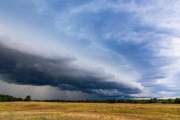 Storm cyclone over rural landscape.