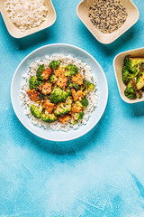 Fried tempeh with rice and broccoli.