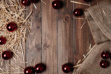 Christmas background of wooden floor with dry straw and Christmas balls