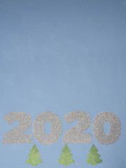 Celebrating the new year 2020. Silver mother-of-pearl paper, number 2020 on a blue background.