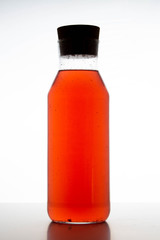 bottle with sweet water, drink for children, transparent glass, white background