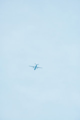 Bottom view of airplane with blue sky at background