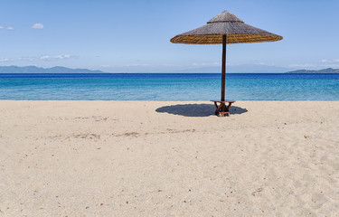 Umbrella on beautiful sand beach. Holidays, travel, vacation concept background.