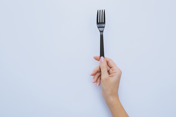 hand holds plastic fork