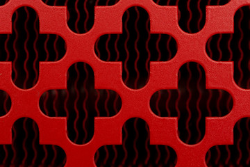 Abstract background in the form of a red monophonic bright surface with crosses with rounded ends.