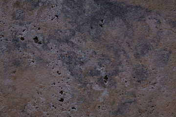 Wall of travertine with stone layers of different colors. Close up architecture macro photography. Creative wallpaper photography.