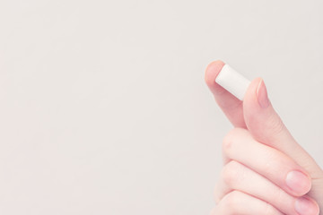 Hand with chewing gum, closeup, copy space