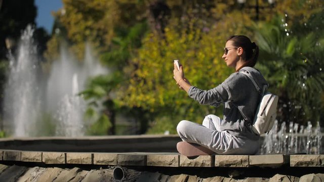 Woman making selphie with mobile phone.