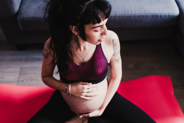 young pregnant woman at home practicing yoga sport. healthy lifestyle