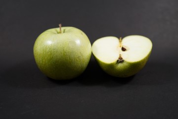 green apples on black background