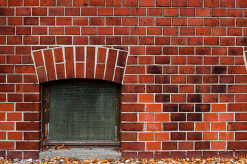 Fototapeta na wymiar Brick wall and cellar window, red brick wall and one Window