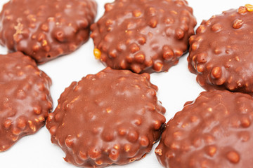 Six сookies with chocolate icing on white background, top view, isolated