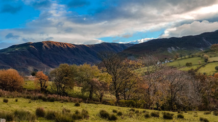 The Newlands Pass scenic valley in autumn with snow capped mountains. Popular destination in the Lake District, Cumbria, United Kingdom. 