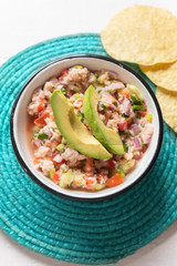 Mexican fish  ceviche with avocado on white background