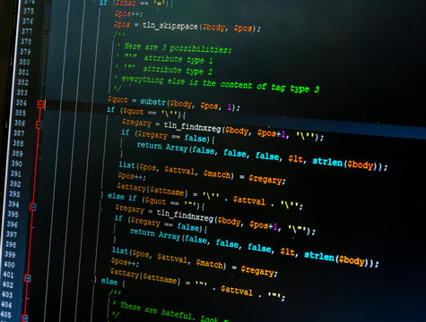 The program for editing the source code of the website - part of the code in php. Colorful code components on a dark background.