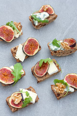 Tasty open sandwiches with fig fruits.