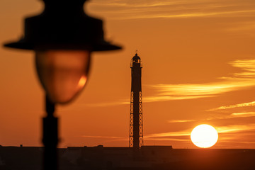 Saint Sebastian Lighthouse Silhouetted against Dramatic Orange Red Sky at Sunset La Caleta Cadiz