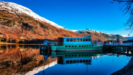 Ullswater, Lake District, Cumbria, UK - Steamers in a autumn day with mountain reflections in the...