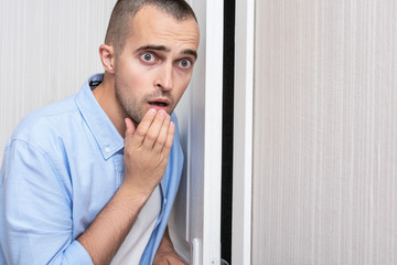 Scared man was listening outside the door, portrait, close up, toned