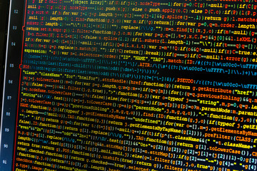 Close up of javascript (jquery) code snippet on monitor screen. Code syntax coloring by editor on dark background.