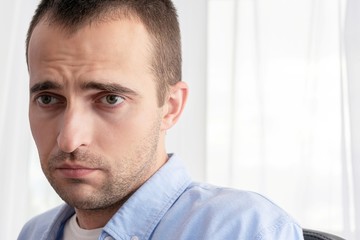 Fototapeta premium Portrait of a sad man is depressed, close up, toned