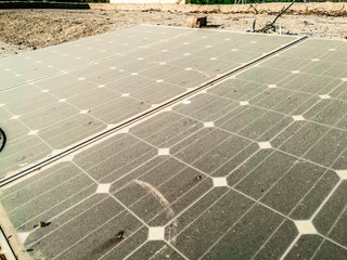 lots of dusty solar energy plates installed at the roof top