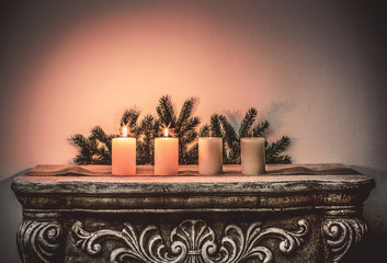Four Advent candles on fireplace