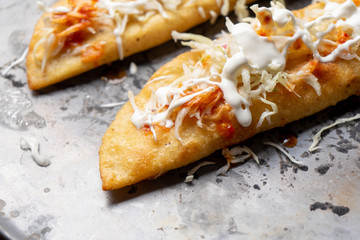 Mexican empanadas with cabbage and red sauce