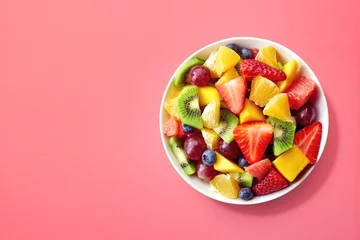 Fototapeten Fresh fruit salad on pink background © baibaz