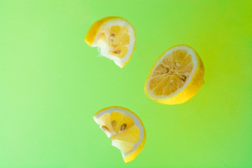 Bright background and lemon pieces. Health. Vitamin C. Citrus fruit. Tropical fruit.