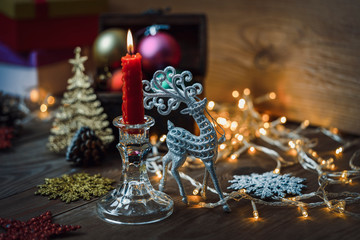 Beautiful silver reindeer toy on the background of Christmas toys.
