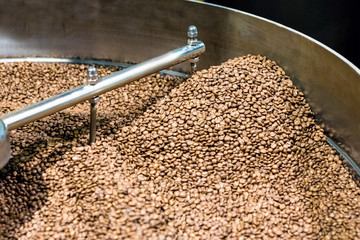 Fresh roasted coffee arabica beans have been cooled down in the cooling bin/tray after completed...