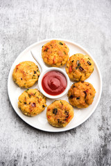 Veg Poha Cutlet or flattened Rice Patties served with tomato ketchup and green chutney