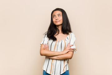 Fototapeta premium Young cute chinese teenager Young blonde woman wearing a coat against a pink background tired of a repetitive task.