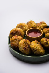 Veg Poha Cutlet or flattened Rice Patties served with tomato ketchup and green chutney
