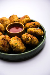 Veg Poha Cutlet or flattened Rice Patties served with tomato ketchup and green chutney