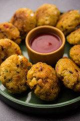 Veg Poha Cutlet or flattened Rice Patties served with tomato ketchup and green chutney