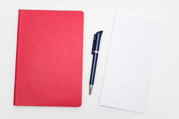 Office worker's Desk, pen and red notebook, letter or white piece of paper, copy space, close up, top view