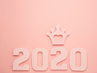 Creative inspiration concepts 2020 with text number and crown on the color background.Business resolution, action plan ideas.Pink color pale shades.