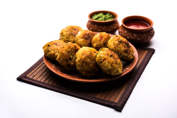Veg Poha Cutlet or flattened Rice Patties served with tomato ketchup and green chutney