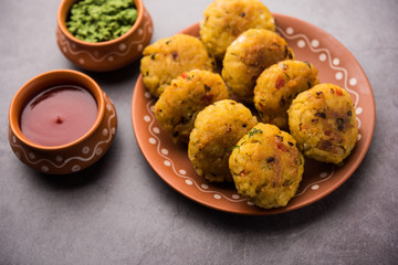 Veg Poha Cutlet or flattened Rice Patties served with tomato ketchup and green chutney