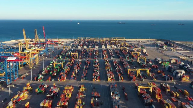 largest docking port of Spain Valencia containers and goods on the quay with cranes aerial sunset view