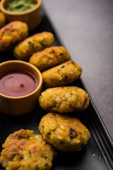 Veg Poha Cutlet or flattened Rice Patties served with tomato ketchup and green chutney
