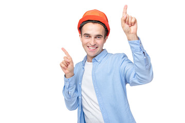 Cheerful builder in hardhat dancing, isolated background, copy space