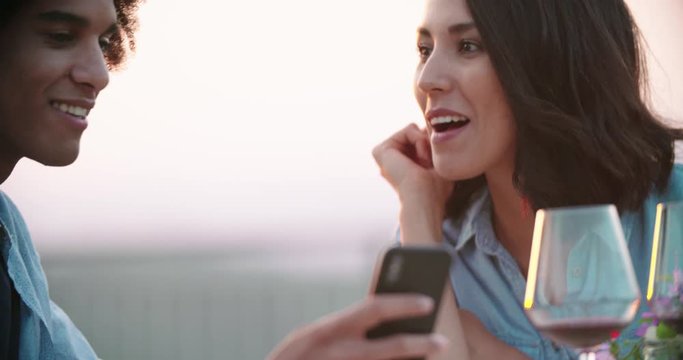 Man ans woman using smartphone device taking a selfie during romantic outdoor dinner at sunset .Friends italian trip in Umbria.4k slow motion