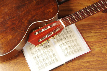 Acoustic guitar and guitar chords on a wooden texture. Chords are not subject to copyright.