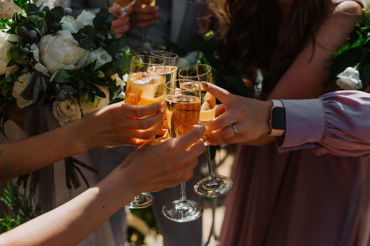 group friends raise champagne four glasses tost