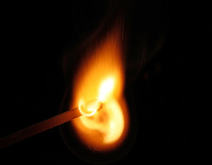 burning match on black background