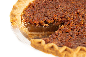 Traditional Pecan PIe with a Slice Cut Out on a White Background